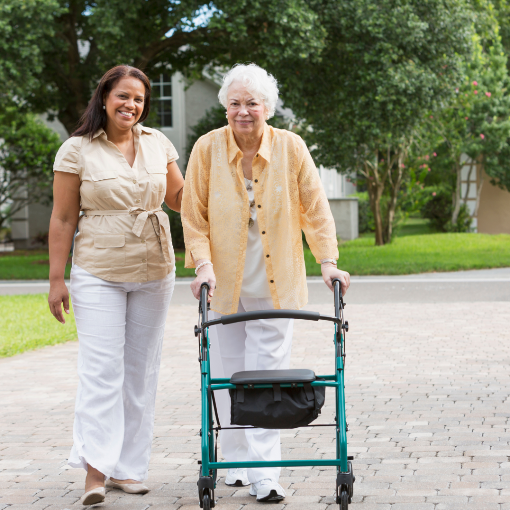 Team Member Walking Outside with Resident | Pelican Valley Senior Living