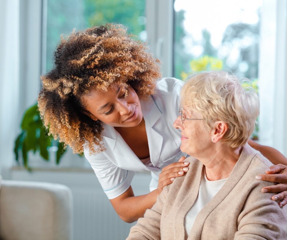 Nurse Looking at Resident, Smiling | Pelican Valley Senior Living