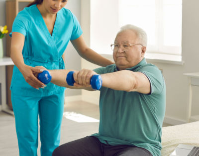 Rehab Team Member and Resident in Therapy Gym | Pelican Valley Senior Living
