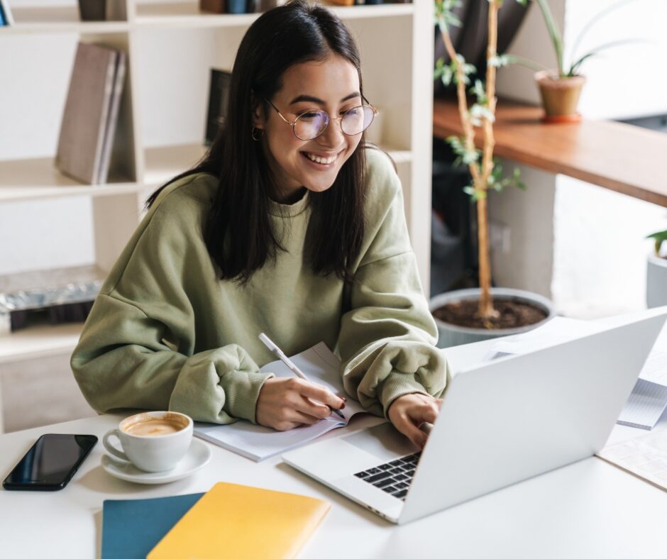 Student Smiling at Laptop | Pelican Valley Senior Living